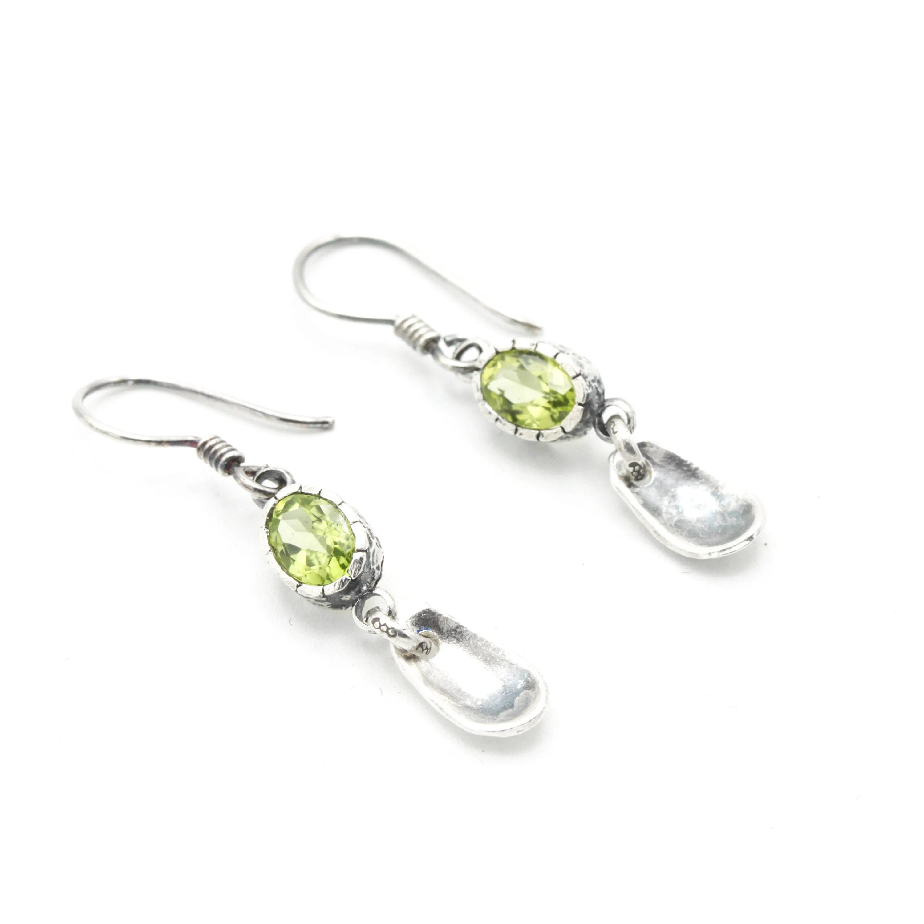 Oval Peridot earrings in silver bezel setting with silver leaf on sterling silver hooks style
